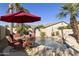 Relaxing backyard oasis with a sparkling pool, patio furniture, and lush landscaping at 1893 E San Carlos Pl, Chandler, AZ 85249