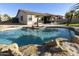 Inviting kidney-shaped pool surrounded by rocks, perfect for relaxation at 1893 E San Carlos Pl, Chandler, AZ 85249