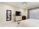 Bright bedroom with a dresser, TV, and large window at 19027 N 269Th Dr, Buckeye, AZ 85396