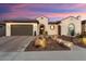 Beautiful stucco home with a tile roof, landscaped yard, and two-car garage at 19027 N 269Th Dr, Buckeye, AZ 85396