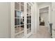 Hallway with French doors leading to an office at 19027 N 269Th Dr, Buckeye, AZ 85396