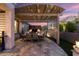 Pergola covered patio with outdoor dining furniture and fire pit at 19027 N 269Th Dr, Buckeye, AZ 85396