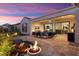 Evening view of backyard patio with seating area and fire pit at 19027 N 269Th Dr, Buckeye, AZ 85396