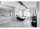 Living room with black leather sectional sofa and wood-look floors at 1905 E University Dr # 207, Tempe, AZ 85288