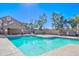 Community pool with surrounding patio furniture and trees at 1905 E University Dr # 207, Tempe, AZ 85288