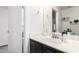 Well-lit bathroom featuring a sleek vanity with black cabinets and modern fixtures at 222 S 223Rd Dr, Buckeye, AZ 85326