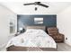 Cozy bedroom features modern decor, a ceiling fan, and natural light at 222 S 223Rd Dr, Buckeye, AZ 85326