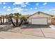 Single-story home with landscaped front yard, palm trees, and a two-car garage at 2242 Leisure World --, Mesa, AZ 85206