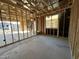 New home living room under construction. Exterior view visible through window at 22844 E Lords Way, Queen Creek, AZ 85142