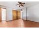 Bedroom with tile floors, double door closet, and access to bathroom at 2407 W Laurel Ln, Phoenix, AZ 85029