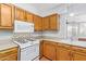 View of kitchen with wood cabinets, tile flooring, and a microwave at 2407 W Laurel Ln, Phoenix, AZ 85029