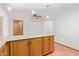 Kitchen island with wood cabinets and tile flooring at 2407 W Laurel Ln, Phoenix, AZ 85029