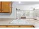 Kitchen sink and countertop with wood cabinets and a view into another room at 2407 W Laurel Ln, Phoenix, AZ 85029