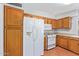 Kitchen with ample wood cabinetry and white appliances at 2407 W Laurel Ln, Phoenix, AZ 85029