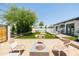 Relaxing backyard with fire pit, artificial turf, and view of the pool at 2816 E Cholla St, Phoenix, AZ 85028