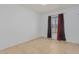 Simple bedroom with tiled floors and a window at 2817 W Marshall Ave, Phoenix, AZ 85017