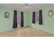 Bedroom with tiled floors, two windows and ceiling fan at 2817 W Marshall Ave, Phoenix, AZ 85017