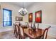 Bright dining room with a beautiful chandelier and large artwork at 28370 N 113Th Way, Scottsdale, AZ 85262