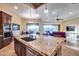 Open kitchen features a large granite island and a view into the adjacent living area at 28370 N 113Th Way, Scottsdale, AZ 85262