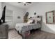 Bright bedroom with a full bed, wood accent wall, and tile flooring at 2963 E Birdsong Ave, San Tan Valley, AZ 85143