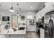 Bright kitchen featuring an island, stainless steel appliances, and white cabinets at 2963 E Birdsong Ave, San Tan Valley, AZ 85143