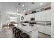 Open kitchen with white cabinets, large island, and gray countertops at 2963 E Birdsong Ave, San Tan Valley, AZ 85143