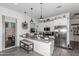 Modern kitchen with island, stainless steel appliances, and white cabinetry at 2963 E Birdsong Ave, San Tan Valley, AZ 85143