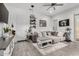 Cozy living room with a sectional sofa, coffee table, and large windows at 2963 E Birdsong Ave, San Tan Valley, AZ 85143