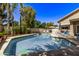 Inviting kidney-shaped pool with surrounding patio and lush landscaping at 302 S Laguna Dr, Gilbert, AZ 85233