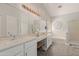 Double vanity bathroom with soaking tub and walk-in shower at 302 S Laguna Dr, Gilbert, AZ 85233