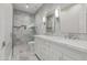 Elegant bathroom with double vanity, marble counters, and a walk-in shower at 302 S Laguna Dr, Gilbert, AZ 85233