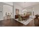 Elegant dining room with hardwood floors, chandelier, and access to kitchen at 302 S Laguna Dr, Gilbert, AZ 85233