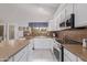 Well-equipped kitchen with white cabinets and granite countertops at 302 S Laguna Dr, Gilbert, AZ 85233