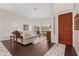 Living room with hardwood floors, beige couch, and a view to entryway at 302 S Laguna Dr, Gilbert, AZ 85233