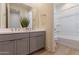 Bathroom with double vanity, gray cabinets, and bathtub at 3238 W Garnet St, San Tan Valley, AZ 85144