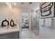 Modern bathroom with a walk-in shower and dual vanity at 3238 W Garnet St, San Tan Valley, AZ 85144