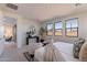 Serene bedroom with a bed and two armchairs near large windows at 3238 W Garnet St, San Tan Valley, AZ 85144