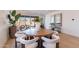 Bright dining area with wood table and white chairs, adjacent to living room at 3238 W Garnet St, San Tan Valley, AZ 85144