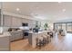 Open kitchen with gray cabinets, marble island, and stainless steel appliances at 3238 W Garnet St, San Tan Valley, AZ 85144