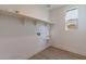 Bright laundry room with built-in shelving and vinyl flooring at 3238 W Garnet St, San Tan Valley, AZ 85144