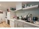 Clean and efficient basement kitchen with white cabinets and stone countertops at 331 E Tuckey Ln, Phoenix, AZ 85012