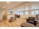 Bright basement recreation room with wood-look floors, comfy seating, and adjacent bathroom at 331 E Tuckey Ln, Phoenix, AZ 85012