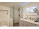 Updated bathroom features a walk-in shower, gray tile, and modern vanity at 331 E Tuckey Ln, Phoenix, AZ 85012