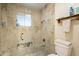 Clean bathroom with a glass-enclosed shower and neutral tile at 331 E Tuckey Ln, Phoenix, AZ 85012