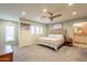 Spacious bedroom with a king-size bed, plush carpet, and ceiling fan at 331 E Tuckey Ln, Phoenix, AZ 85012