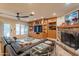 Living room featuring a fireplace, built-in shelves, and a large TV at 331 E Tuckey Ln, Phoenix, AZ 85012