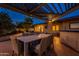 Backyard patio with dining table under a pergola, near the house and pool at 331 E Tuckey Ln, Phoenix, AZ 85012