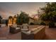 Evening view of backyard patio with wicker furniture, creating a relaxing outdoor space at 331 E Tuckey Ln, Phoenix, AZ 85012