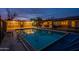 Swimming pool area at dusk, surrounded by a fence and patio at 331 E Tuckey Ln, Phoenix, AZ 85012