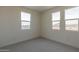 Bright bedroom with two large windows and carpet at 35775 N Zinc Dr, San Tan Valley, AZ 85144